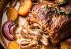 Apple cider braised pork shoulder dish garnished and ready to serve