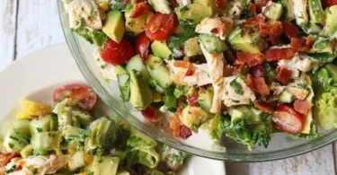 Bacon Avocado Chicken Salad topped with Lemon Vinaigrette on a plate