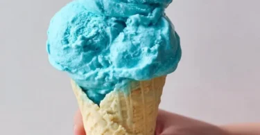Scoop of Blue Moon Ice Cream in a colorful cone