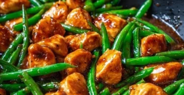 Juicy chicken breast served with fresh green beans on a plate