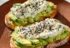 Delicious cottage cheese avocado toast topped with herbs and seeds.