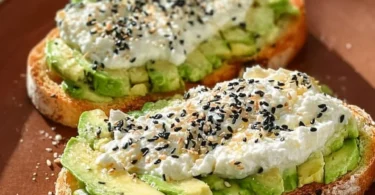Delicious cottage cheese avocado toast topped with herbs and seeds.