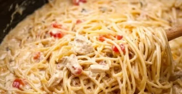 Crock Pot Cheesy Chicken Spaghetti served in a bowl with melted cheese on top