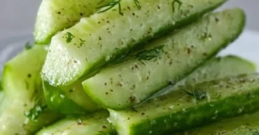 Jar of homemade Garlic Dill Cucumbers with herbs and spices
