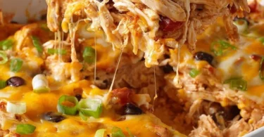 Healthy chicken taco casserole with colorful toppings served in a baking dish.