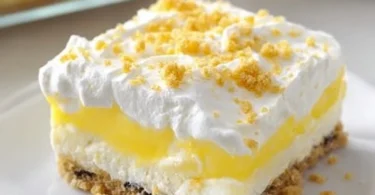 Heavenly Oreo Lemon Dessert with a creamy lemon layer and crushed Oreo crust