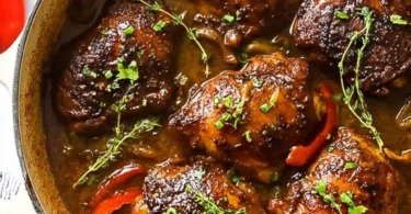 Slow cooker jerk chicken with vibrant herbs and spices in a dish