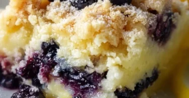 Delicious Lemon Blueberry Cheesecake Dump Cake topped with fresh blueberries.