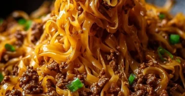 Delicious bowl of Mongolian Ground Beef Noodles with vegetables and spices