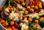 Roasted veggie and chickpea bowls topped with maple dijon tahini dressing