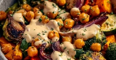 Roasted veggie and chickpea bowls topped with maple dijon tahini dressing