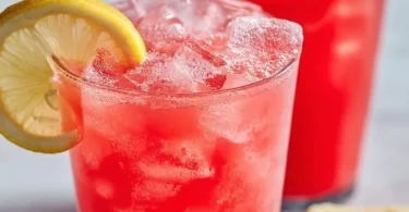 A refreshing glass of watermelon lemonade with garnishes